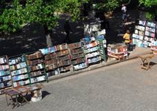 A street vendor selling books

Description automatically generated
