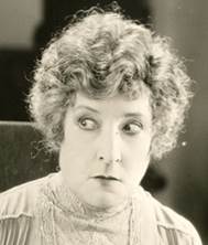A person with curly hair looking up

Description automatically generated
